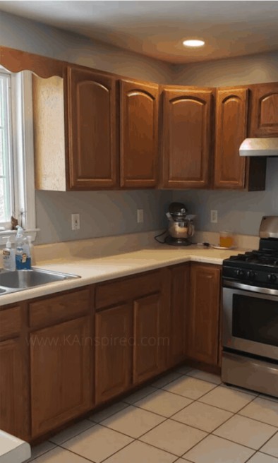 Kitchen before renovation with dark wood cabinets and tile floor